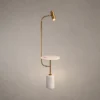 Radisson modern gold floor lamp featuring a curved frame, cylindrical spotlight, circular plate, and white marble base