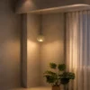Ronde green glass pendant light illuminating a minimalist interior with warm neutral finishes