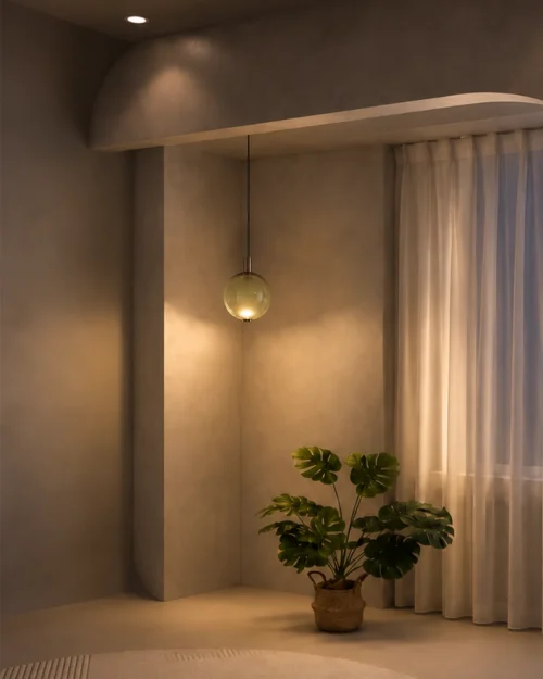 Ronde green glass pendant light illuminating a minimalist interior with warm neutral finishes