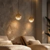 Two Ronde yellow glass pendant lights suspended above a contemporary seating area