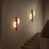 S-Shaped wall lamps illuminating a modern staircase