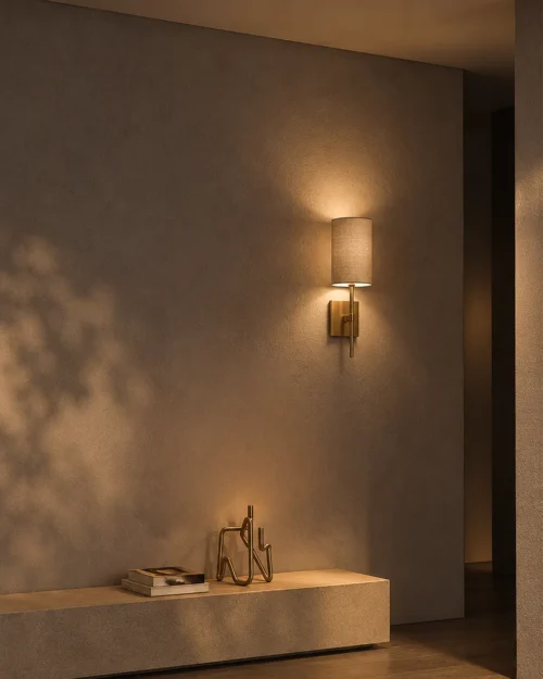 Serafina gold and grey fabric wall lamp providing soft illumination above a minimalist console