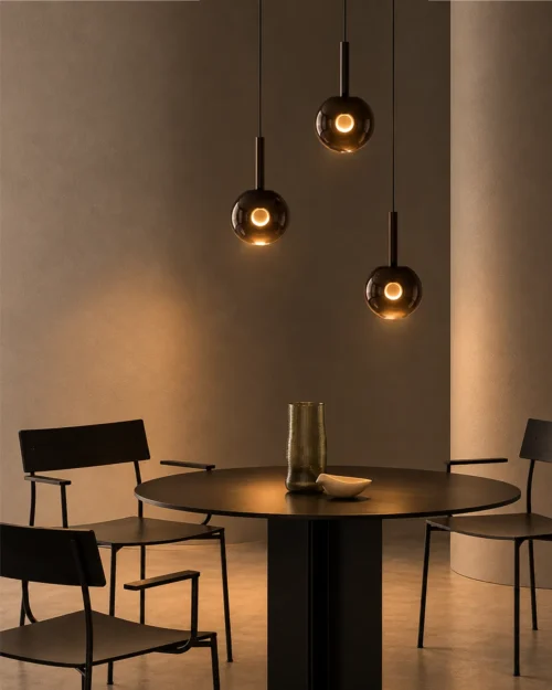 Sfera Glass Pendant Lights Contemporary Dining Room Three Sfera smoky glass pendant lights arranged at varying heights above a modern dining table