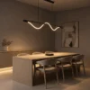 Sicily linear LED chandelier illuminating a contemporary dining area