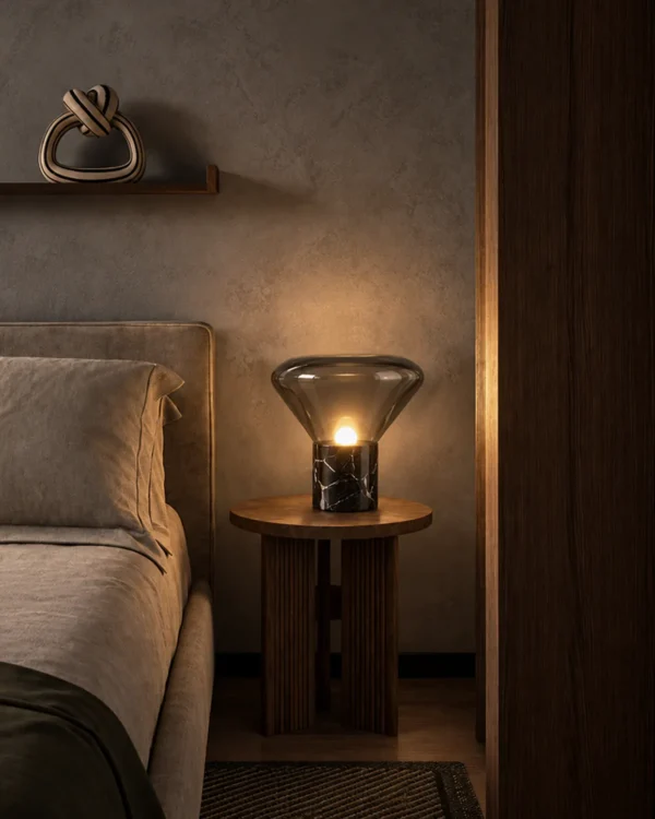 Silas table lamp providing warm illumination beside a bed