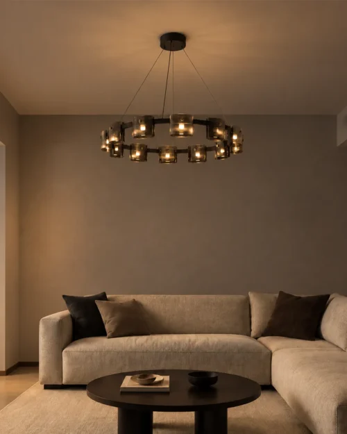 Svein black circular chandelier with decorative glass lights above a neutral sofa