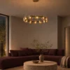 Svein gold and amber chandelier illuminating a modern living room with a burgundy sofa