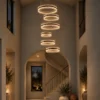 Tianna cascading chandelier with six illuminated rings in a contemporary staircase interior
