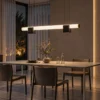 Viano linear chandelier with marble accents above a contemporary dining table