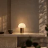 Vienna Table Lamp Modern Console Vienna Rose Gold table lamp with illuminated dome shade on a modern side table