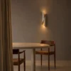 Virgil Wall Lamp Modern Dining Room Virgil vertical wall lamp illuminating a warm contemporary dining room